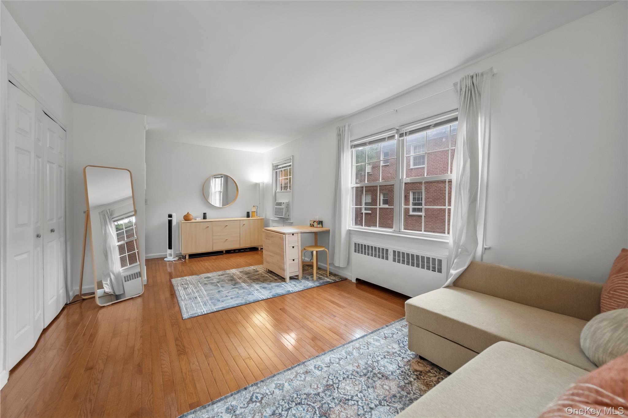 182 Pinewood Road, Unit 23 Hartsdale, NY 10530 - Photo 13 of 16 a living room with furniture and a large window