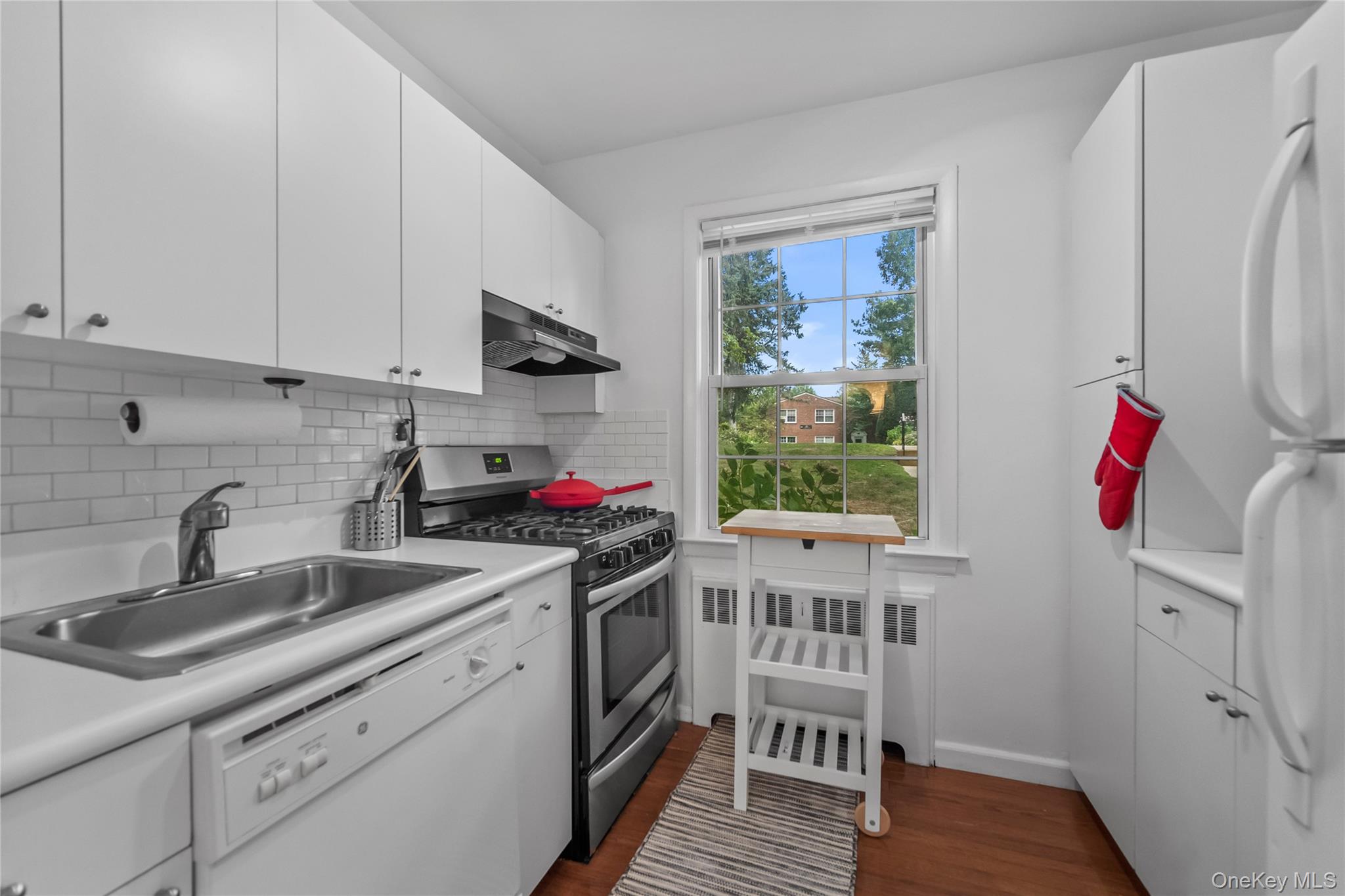 182 Pinewood Road, Unit 23 Hartsdale, NY 10530 - Photo 5 of 16 a kitchen with a sink cabinets and wooden floor