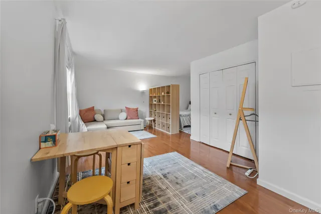 a view of a workspace with furniture and wooden floor