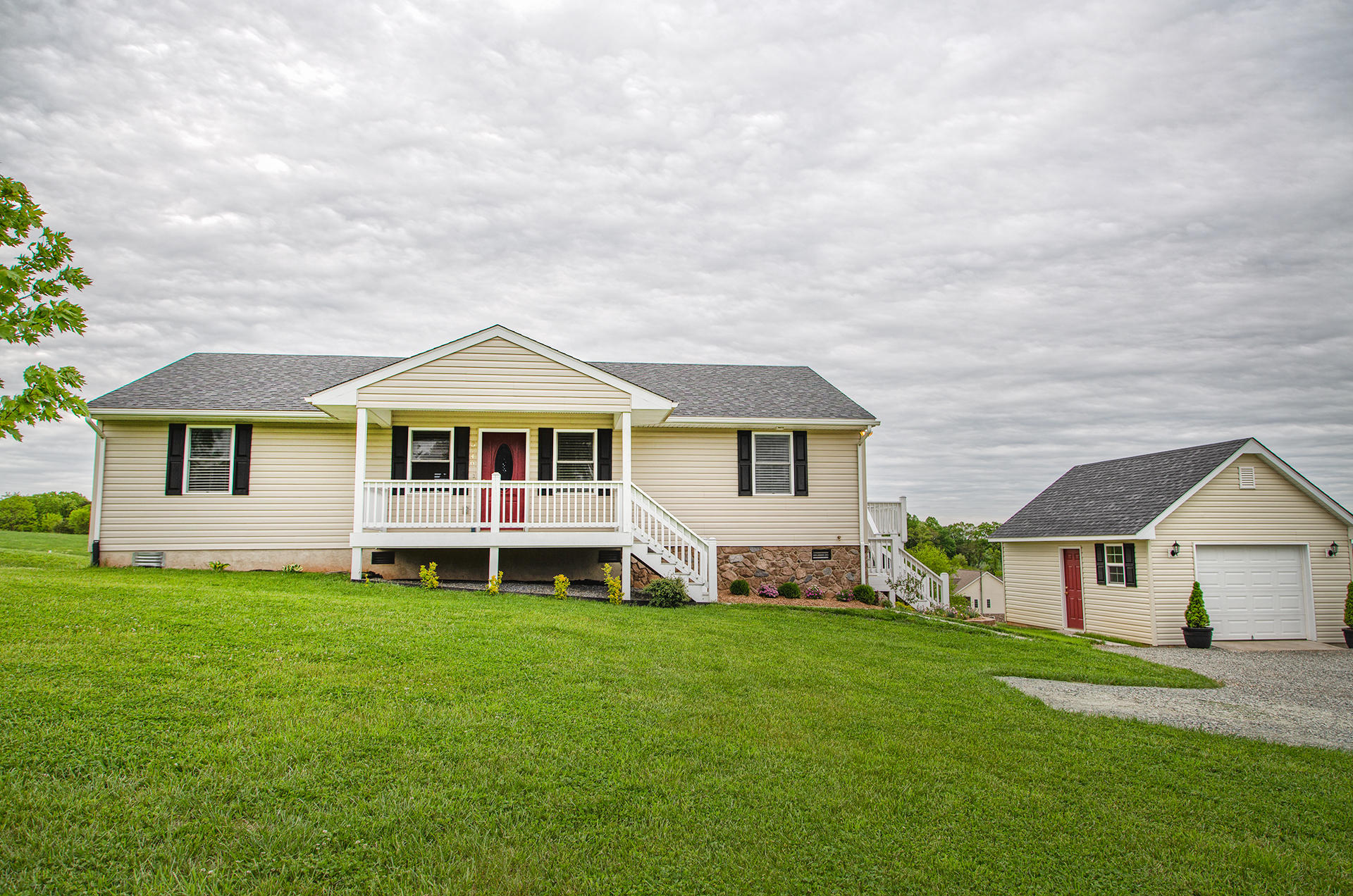 3746 Horseshoe Bend Road Goodview, VA 24095 - Photo 1 of 35 a front view of a house with a garden and yard