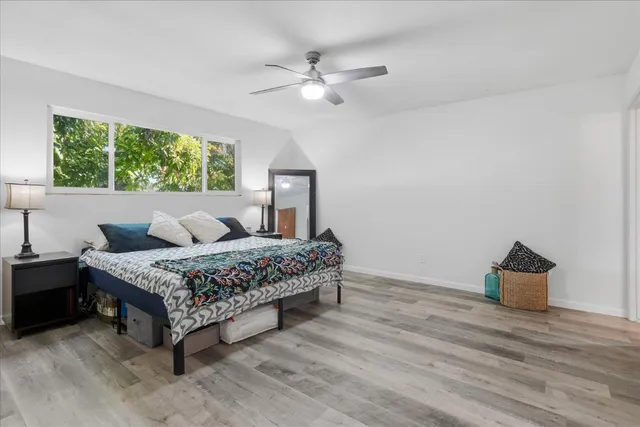 a bedroom with a bed and a potted plant