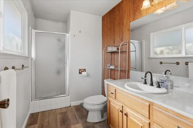 a bathroom with a sink a toilet and shower