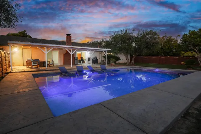 a view of a swimming pool with outdoor seating