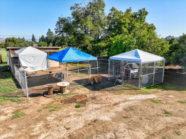 an aerial view of a house with a yard basket ball court and outdoor seating