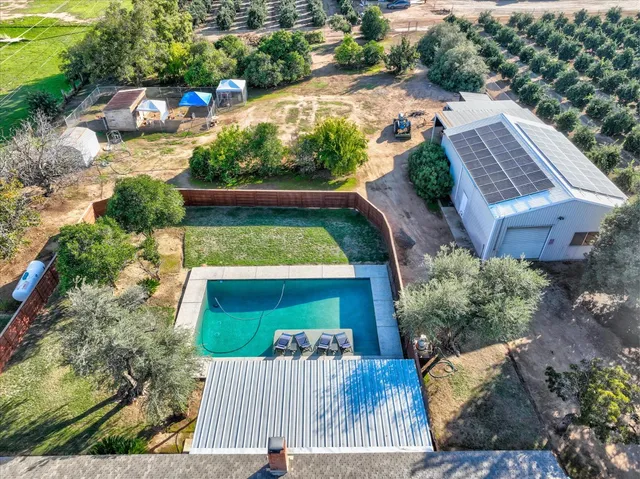 a view of a house with backyard and swimming pool