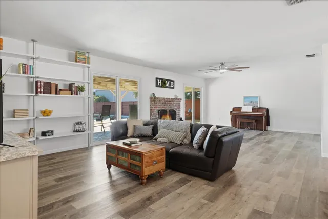 a living room with furniture and a wooden floor