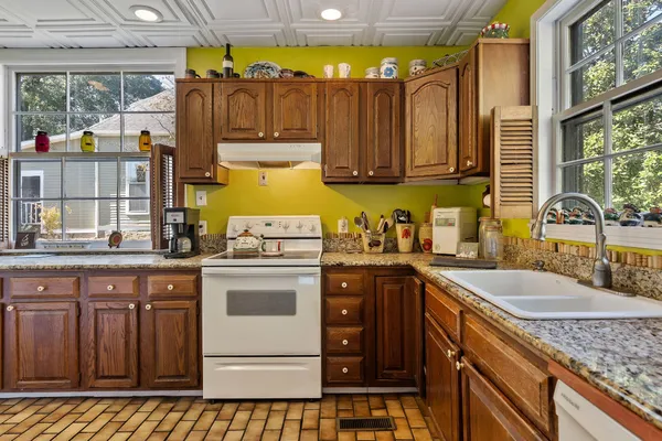 a kitchen with stainless steel appliances granite countertop a sink and cabinets
