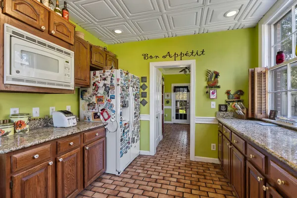 a kitchen with stainless steel appliances granite countertop a stove a sink dishwasher and a refrigerator