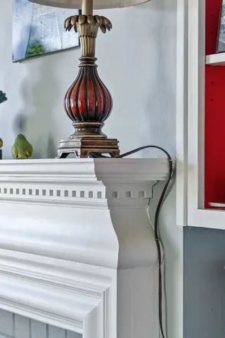 a view of a dining room with furniture a chandelier and a window