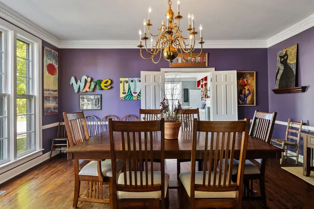 a view of a dining room with furniture and a window