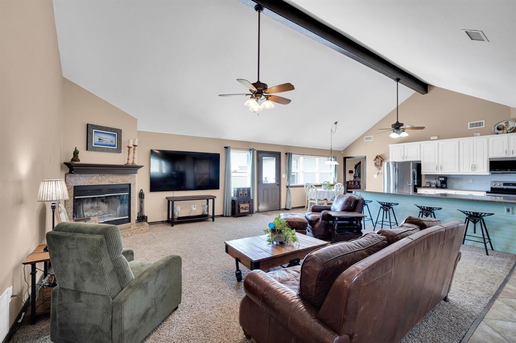 130 Eubanks Road Maypearl, TX 76064 - Photo 18 of 39 a living room with furniture a flat screen tv and a fireplace
