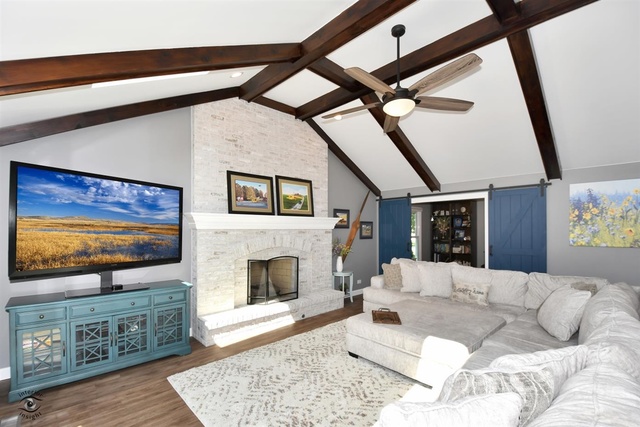 1536 Carlyle Road Naperville, IL 60564 - Photo 12 of 65 a living room with furniture a flat screen tv and a fireplace