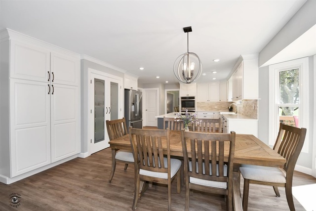 1536 Carlyle Road Naperville, IL 60564 - Photo 18 of 65 a view of a dining room with furniture window and wooden floor