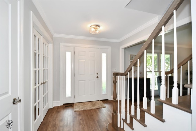 1536 Carlyle Road Naperville, IL 60564 - Photo 3 of 65 a view of a hallway with wooden floor and entryway