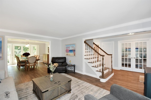 1536 Carlyle Road Naperville, IL 60564 - Photo 24 of 65 a living room with furniture and wooden floor next to a window