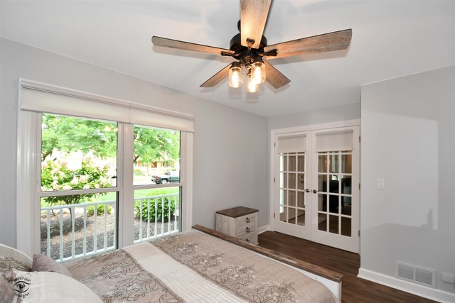 1536 Carlyle Road Naperville, IL 60564 - Photo 26 of 65 a bedroom with a bed and wooden floor