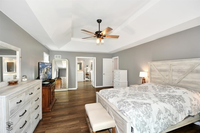 1536 Carlyle Road Naperville, IL 60564 - Photo 30 of 65 a spacious bedroom with a bed a dresser and wooden floor