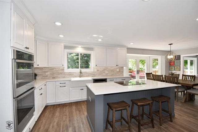 1536 Carlyle Road Naperville, IL 60564 - Photo 4 of 65 a kitchen with center island white cabinets and stainless steel appliances