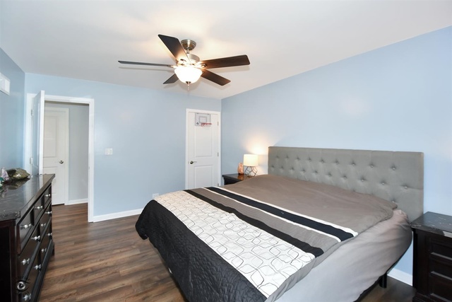 1536 Carlyle Road Naperville, IL 60564 - Photo 36 of 65 a bedroom with a bed and wooden floor