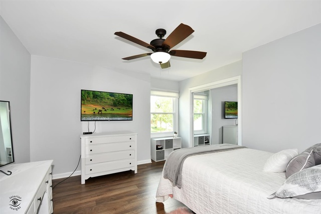 1536 Carlyle Road Naperville, IL 60564 - Photo 39 of 65 a bedroom with a bed and a flat tv screen on dresser