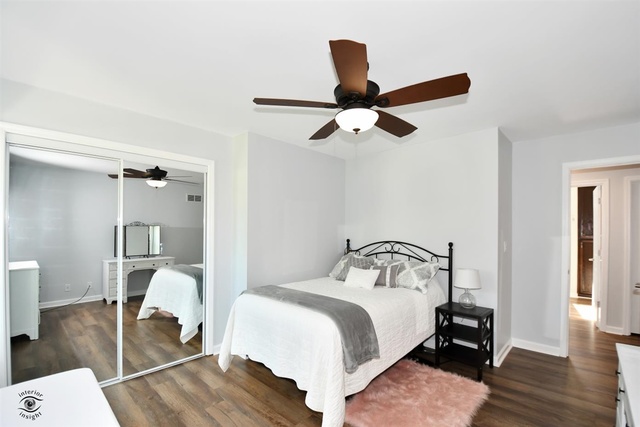 1536 Carlyle Road Naperville, IL 60564 - Photo 40 of 65 a bedroom with a bed and wooden floor