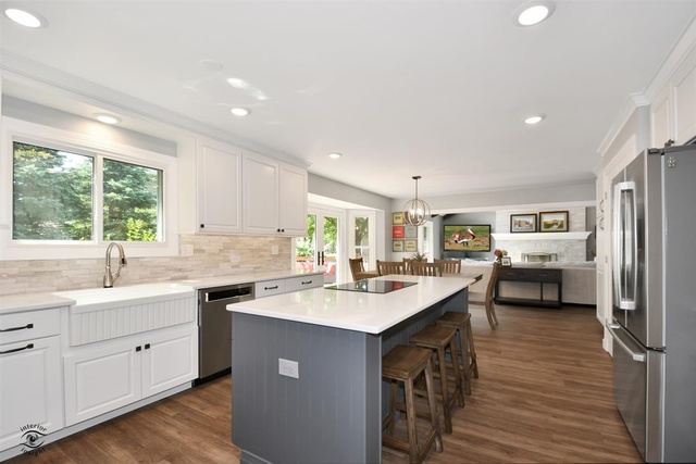 1536 Carlyle Road Naperville, IL 60564 - Photo 5 of 65 a kitchen with a sink stove cabinets and wooden floor