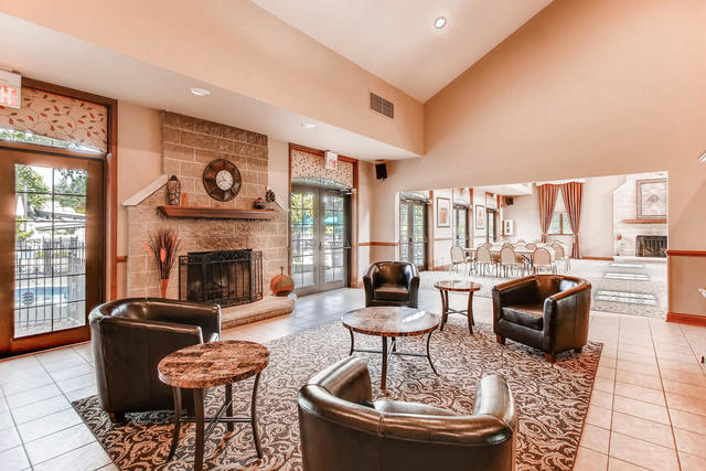 1536 Carlyle Road Naperville, IL 60564 - Photo 56 of 65 a living room with furniture a fireplace and a table