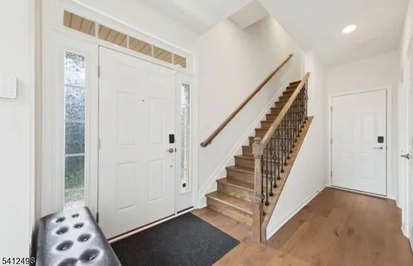 a view of entryway with stairs and wooden floor