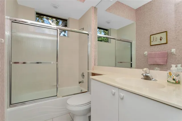 a bedroom with a bed and flat screen tv