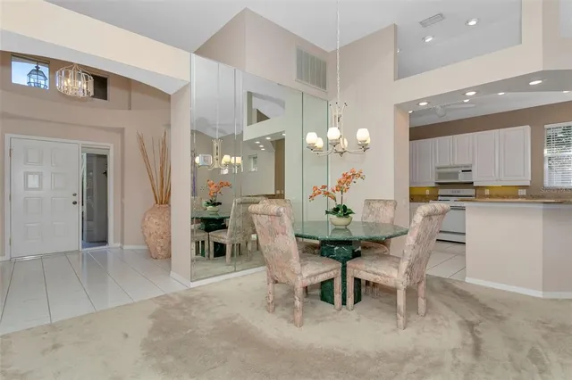 a view of a dining room with furniture and chandelier