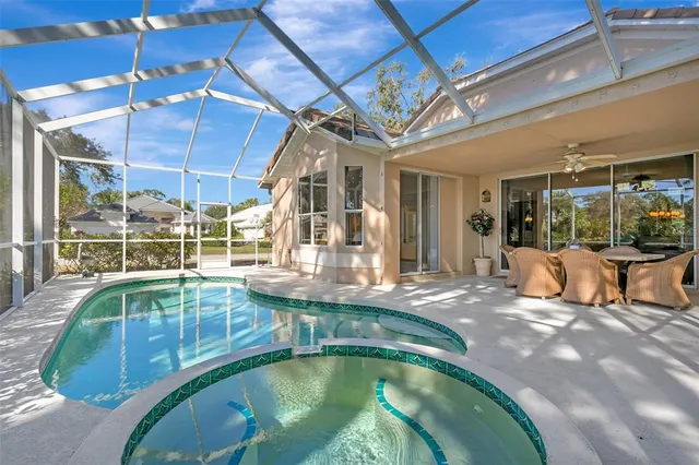 a view of a patio with table and chairs potted plants and large tree