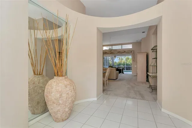 a view of a hallway to a livingroom with furniture