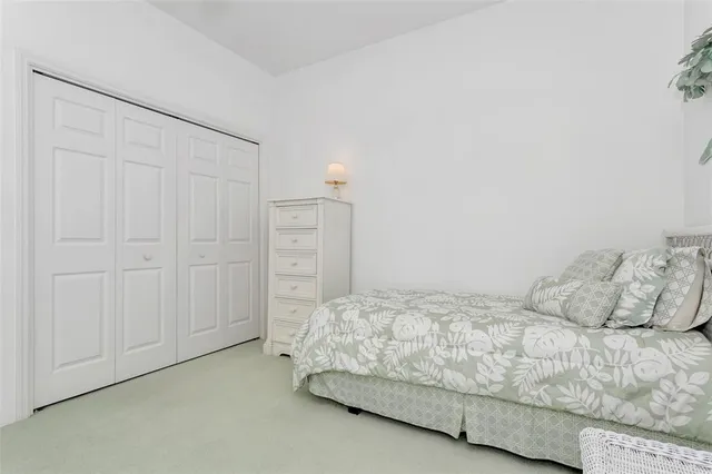 a spacious bedroom with a bed and a window