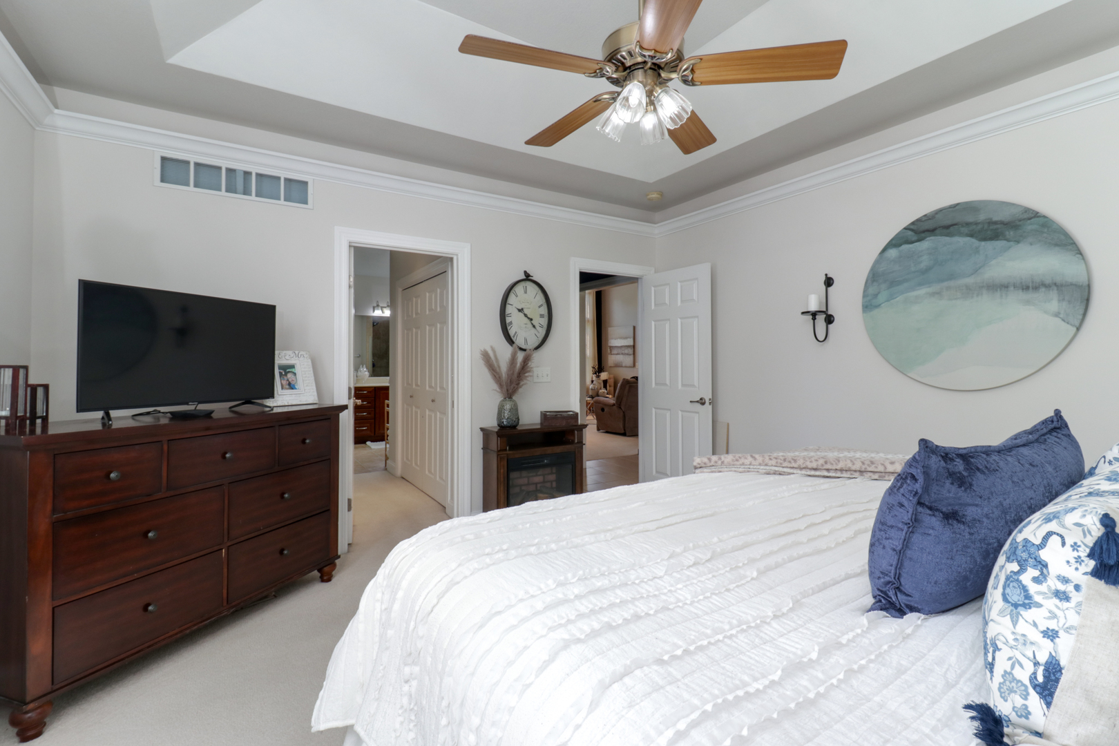 1099 Balsam Road Normal, IL 61761 - Photo 17 of 45 a bedroom with a bed a mirror on dresser and a flat screen tv