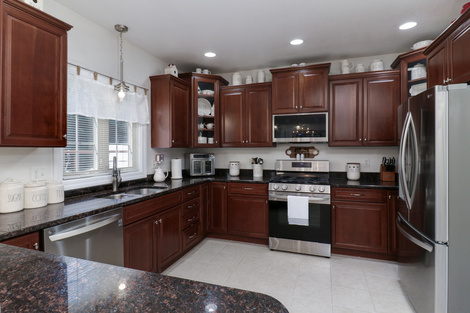1099 Balsam Road Normal, IL 61761 - Photo 10 of 45 a kitchen with kitchen island granite countertop wooden cabinets and a stainless steel appliances