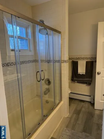 a bathroom with a shower and a sink
