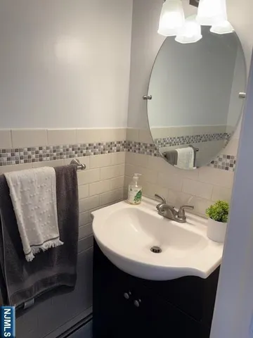 a bathroom with a sink a mirror and vanity