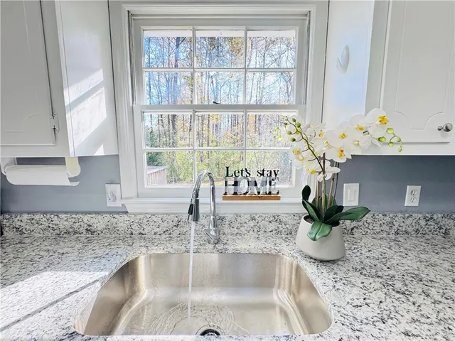 a kitchen with a faucet a sink and a window