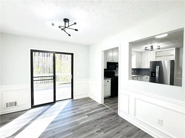 a view of a living room with hardwood floor and a ceiling fan