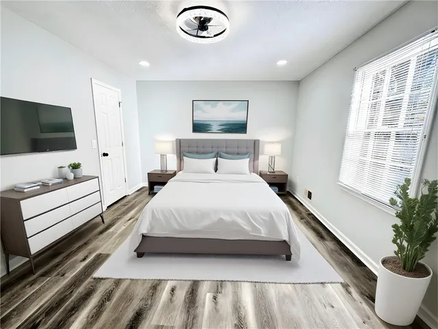 a bedroom with a bed and a flat screen tv