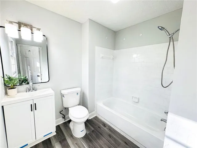 a bathroom with a toilet a sink and a bathtub
