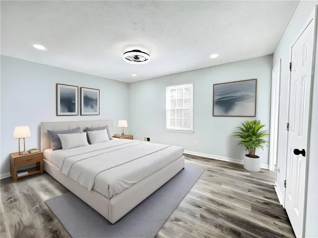 a spacious bedroom with a large bed and a window