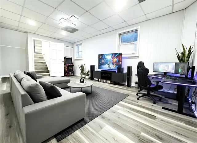 a living room with furniture a fireplace and a flat screen tv