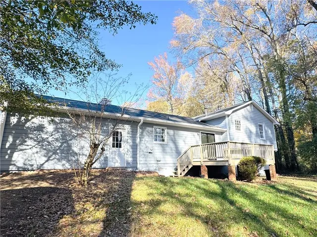 a view of a wooden house with large trees