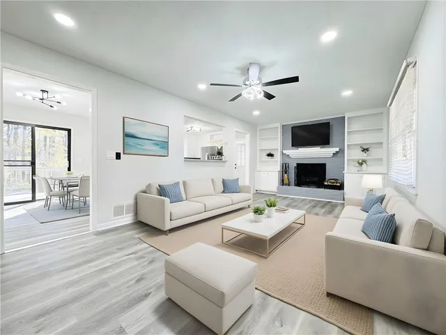 a living room with furniture a fireplace and a flat screen tv