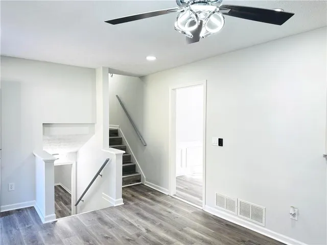 a view of entryway and hall with wooden floor