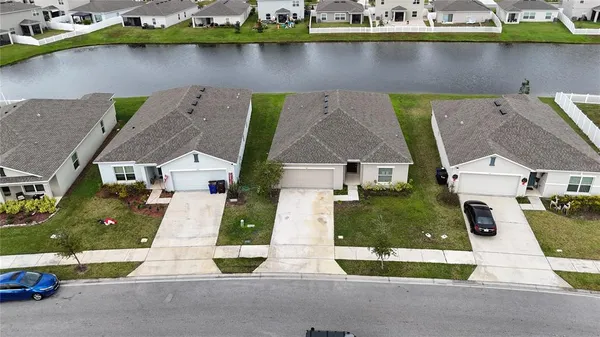 an aerial view of a house with garden space and street view