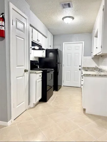 an empty room with a ceiling fan and window
