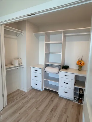 a view of an empty room with cabinet and stairs