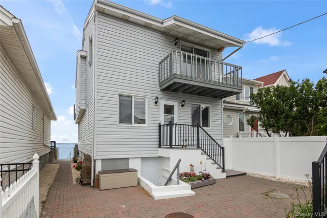 a view of a house with a wooden deck